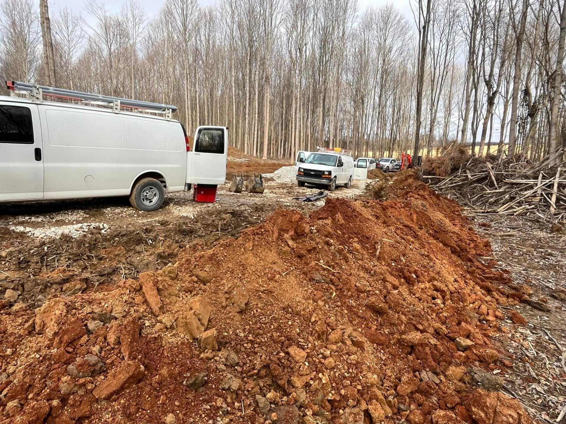A white van is parked next to a pile of dirt | Campbellsburg, IN | Twisted Electric LLC