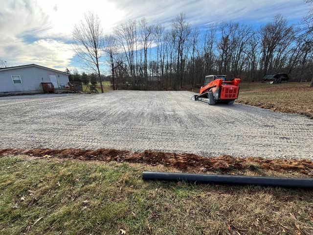 Bulldozer sitting on top of a gravel driveway next to a house - Campbellsburg, IN | Twisted Electric LLC