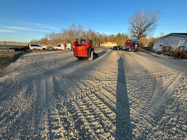 Red tractor driving down a gravel road next to a semi truck - Campbellsburg, IN | Twisted Electric LLC 