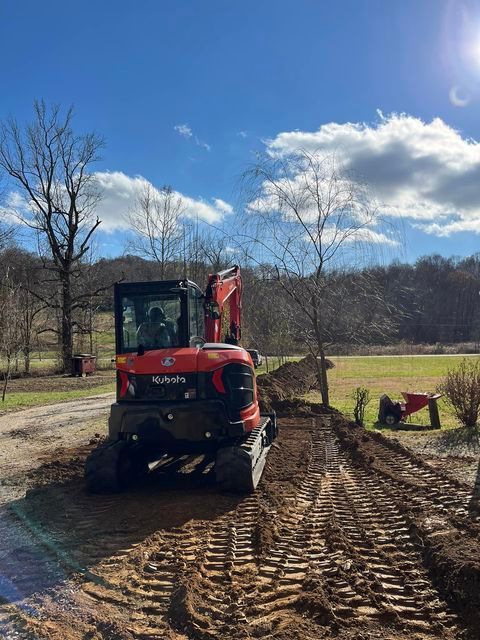 Red excavator driving down a dirt road - Campbellsburg, IN | Twisted Electric LLC 