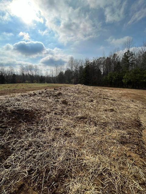 Field covered in hay and dirt with trees - Campbellsburg, IN | Twisted Electric LLC 