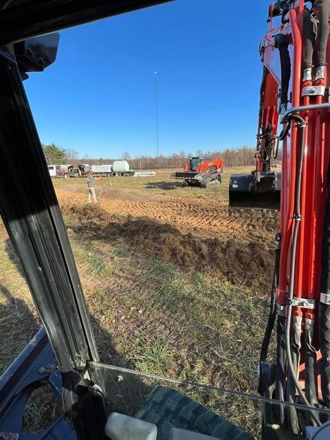 Tractor driving down a dirt road in a field - Campbellsburg, IN | Twisted Electric LLC 