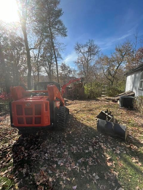 Small orange tractor parked in a yard next to a house - Campbellsburg, IN | Twisted Electric LLC 