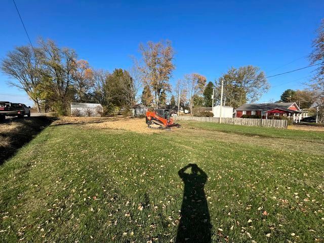 Person taking a picture of a bulldozer in a field - Campbellsburg, IN | Twisted Electric LLC 