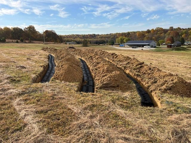 Large pile of dirt in a field with a house in the background - Campbellsburg, IN | Twisted Electric LLC 