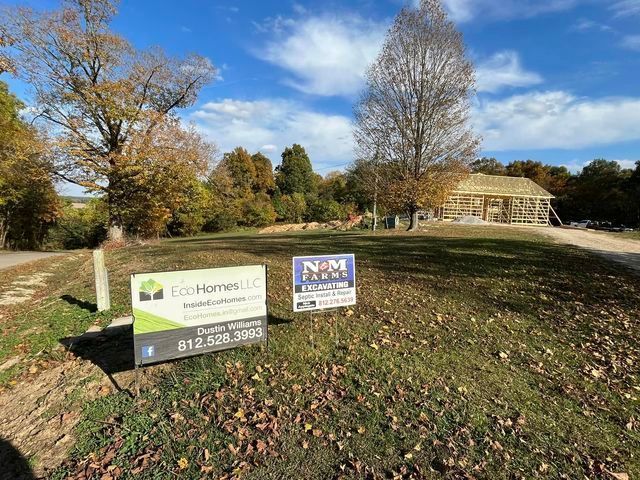 House being built on a lush green hillside next to a dirt road - Campbellsburg, IN | Twisted Electric LLC 