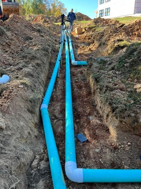 Bunch of blue pipes laying in the dirt in a trench - Campbellsburg, IN | Twisted Electric LLC 
