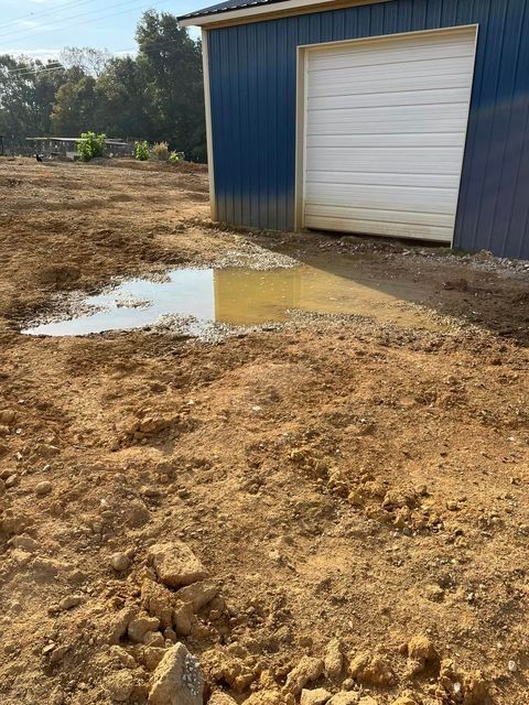 Puddle of water in the dirt in front of a garage door - Campbellsburg, IN | Twisted Electric LLC 