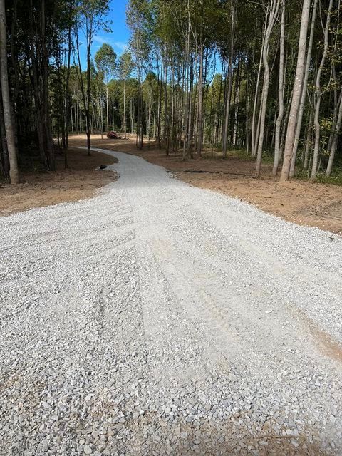 Gravel road going through a forest with trees on both sides - Campbellsburg, IN | Twisted Electric LLC 