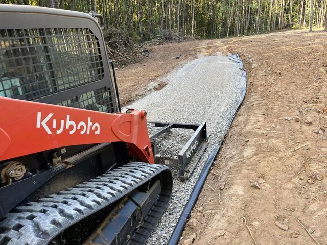 A Red Kubota Skid Steer Is On A Dirt Road — Campbellsburg, IN — Twisted Electric LLC