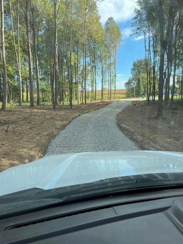 A White Car Is Driving Down A Gravel Road — Campbellsburg, IN — Twisted Electric LLC