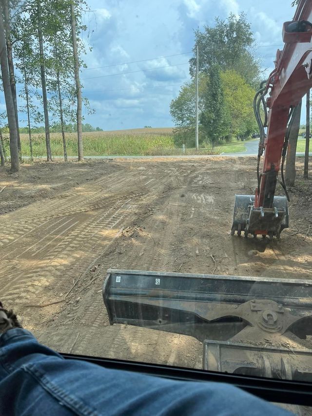 Gravel Is Being Moved By A Red Excavator On A Dirt Road. — Campbellsburg, IN — Twisted Electric LLC