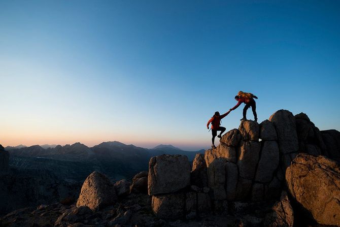 Two people are hiking up a mountain