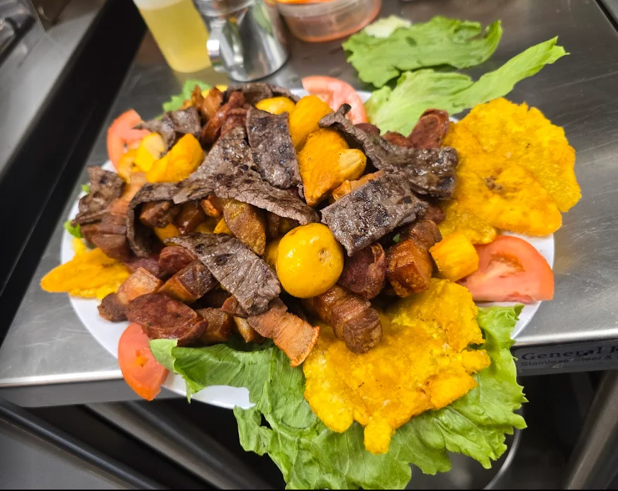 A plate of food with meat and vegetables on a table
