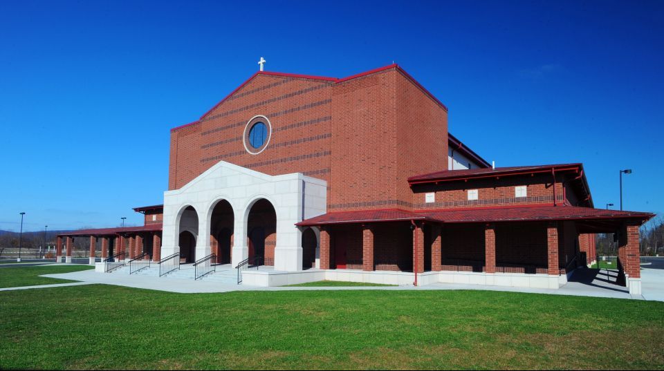 A large red brick building with a white porch