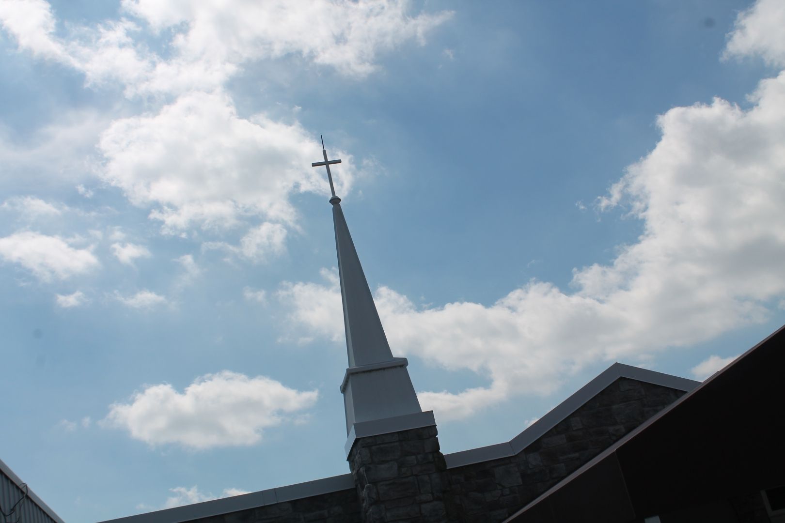 A church steeple with a cross on top of it