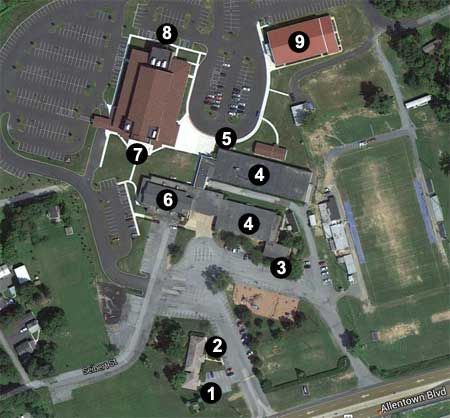 An aerial view of a school with numbers on the buildings