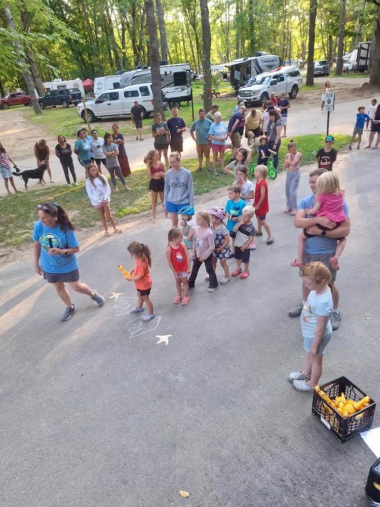A group of people are standing in a parking lot.