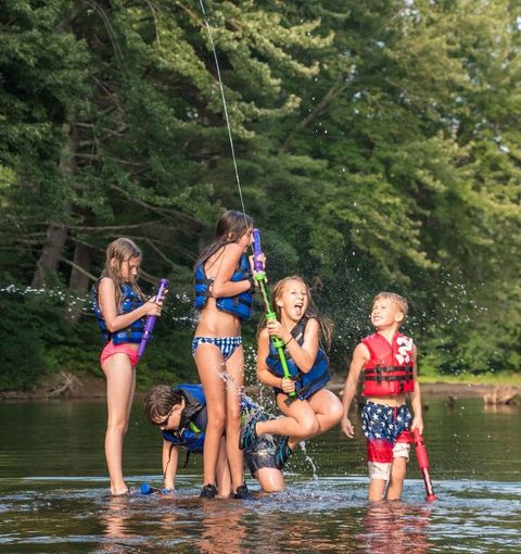 splashing into the saco river on a rope swing