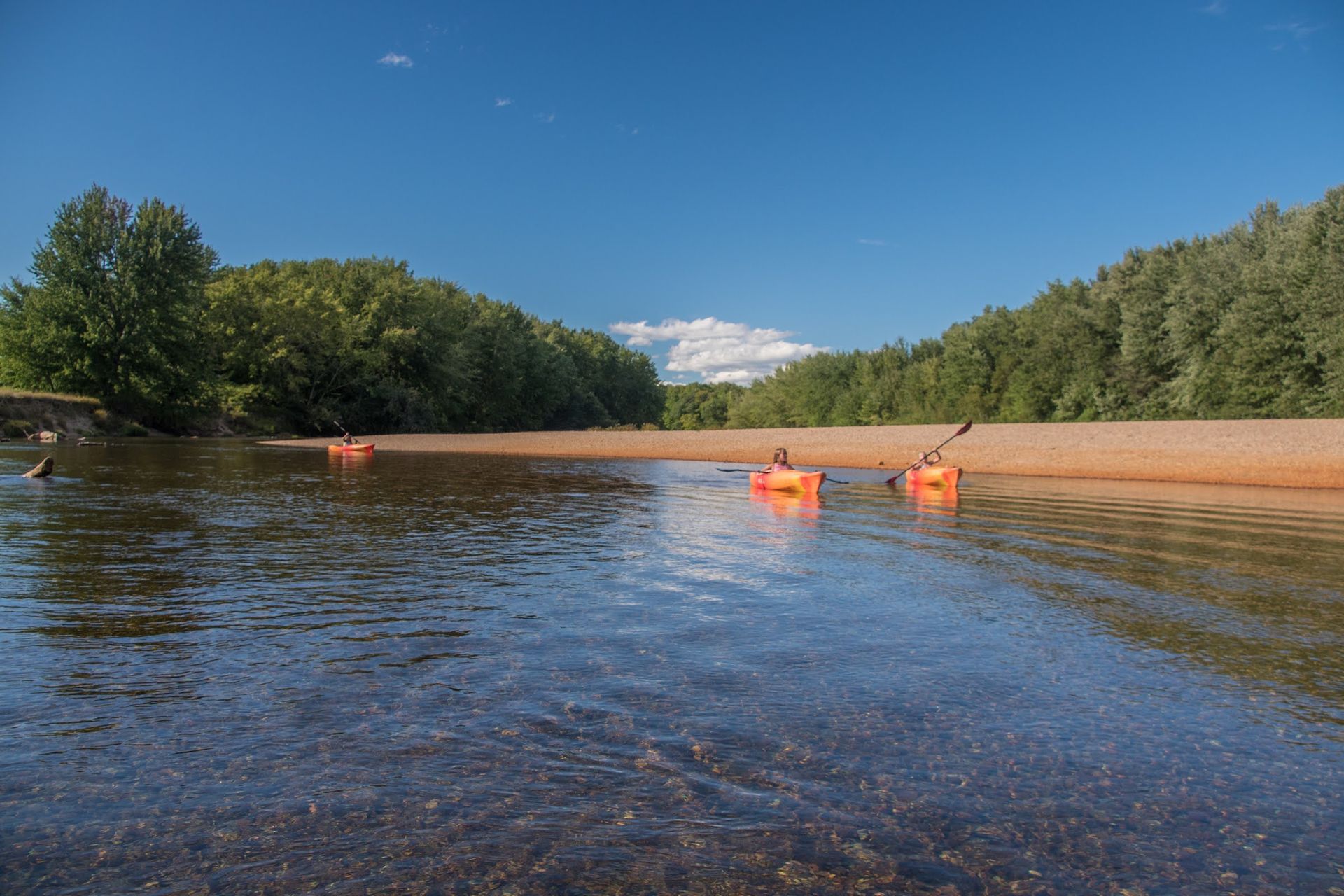 A couple of kayaks are floating on top of a river.