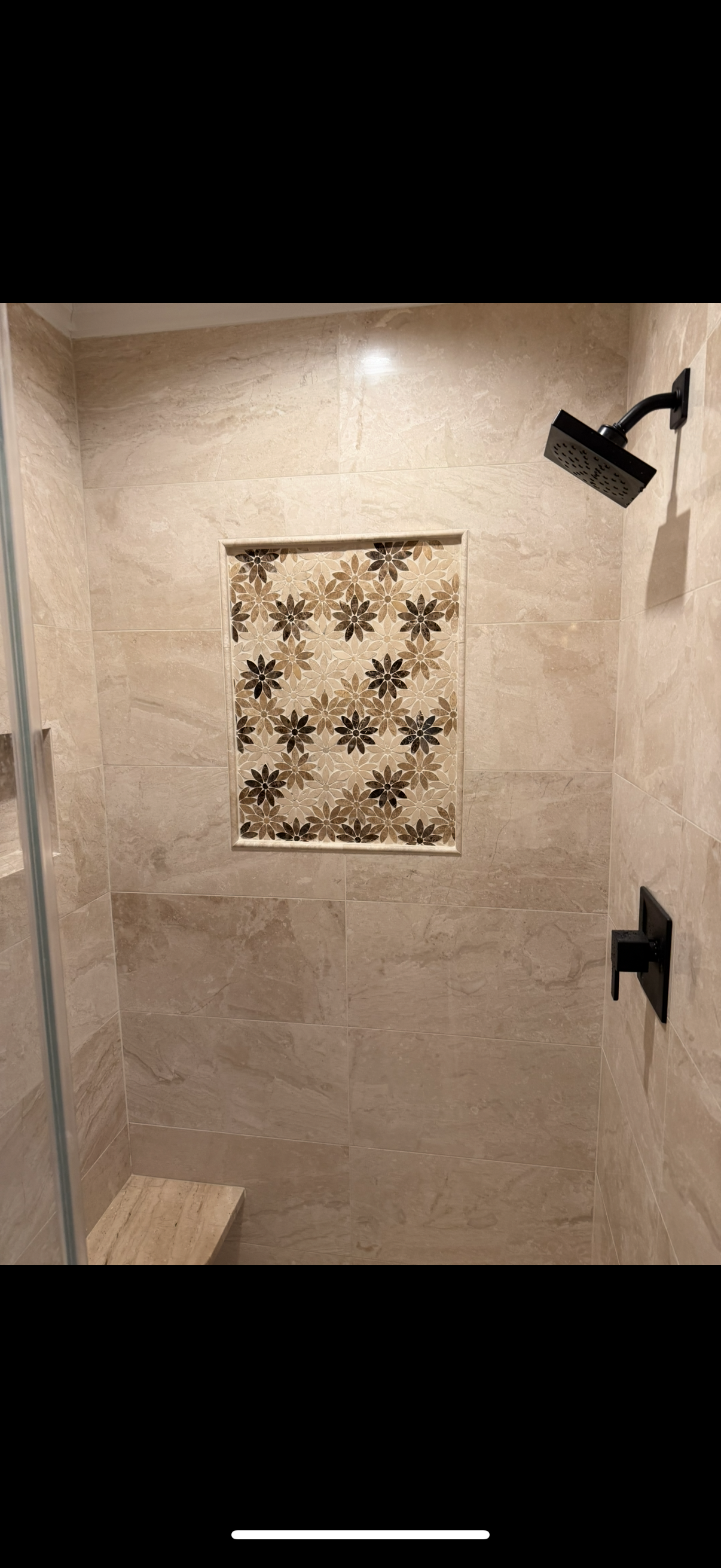 A shower with a floral pattern on the wall and a showerheadin Old Bridge, NJ.