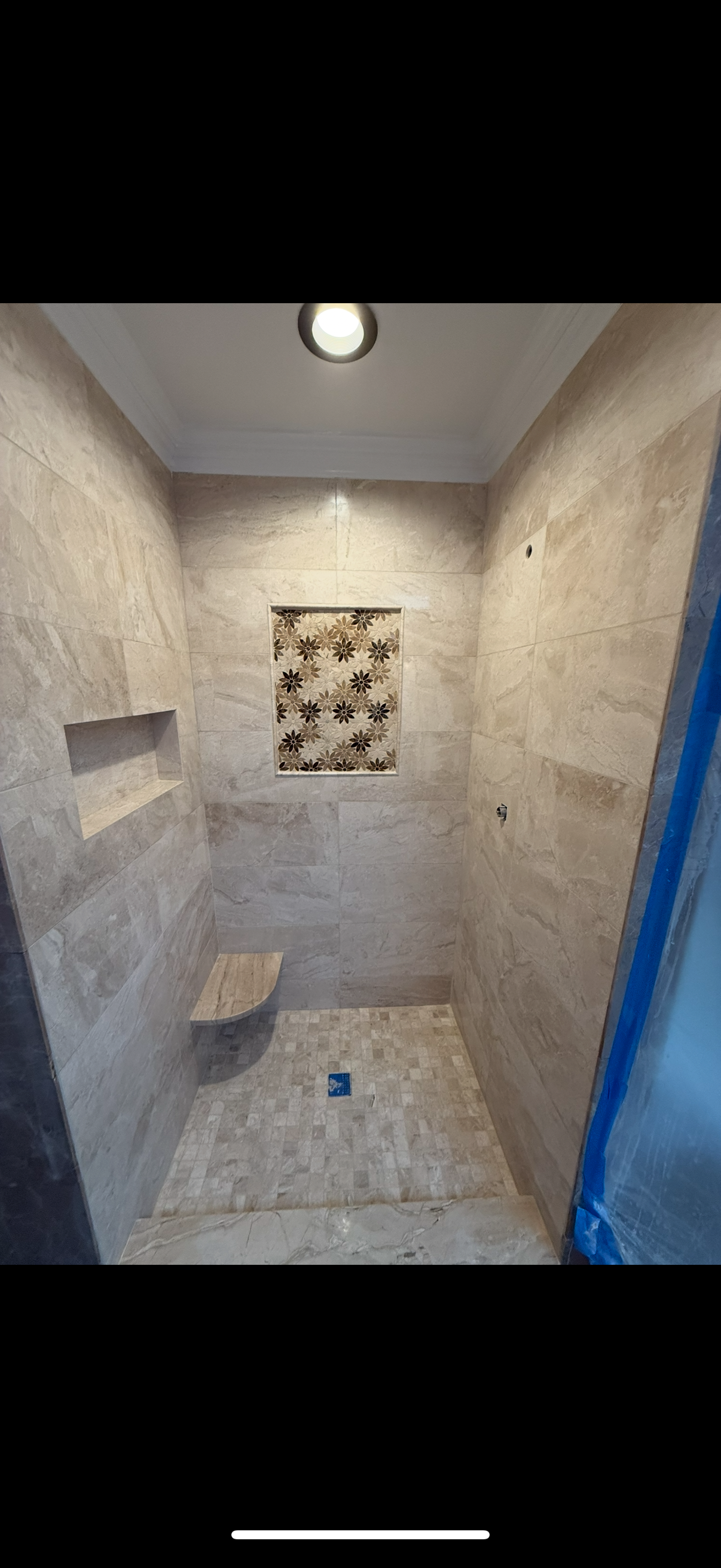A bathroom with a walk-in shower and a bench in Old Bridge, NJ.
