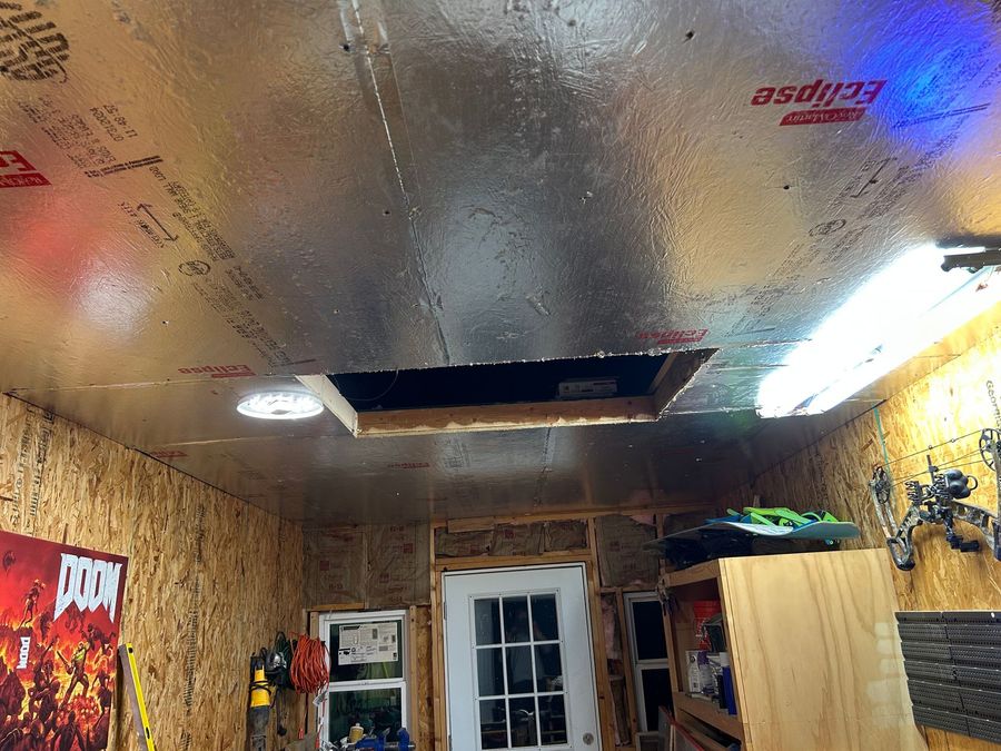 A garage with a ceiling that has a hole in it.