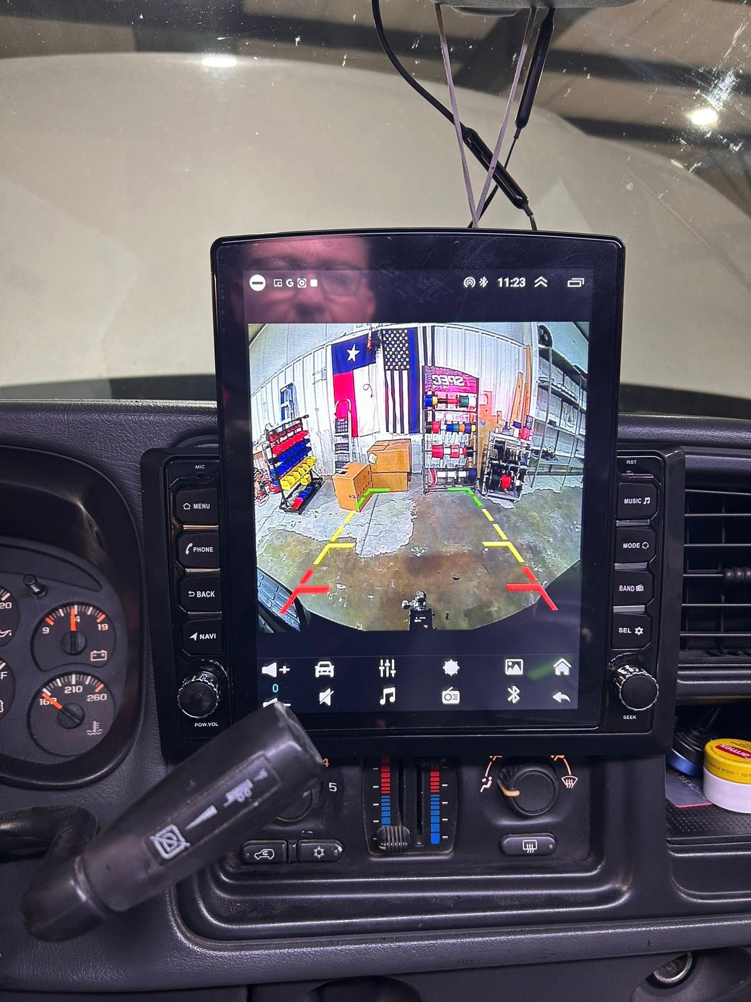 A truck dashboard with a large display showing a reverse camera view.