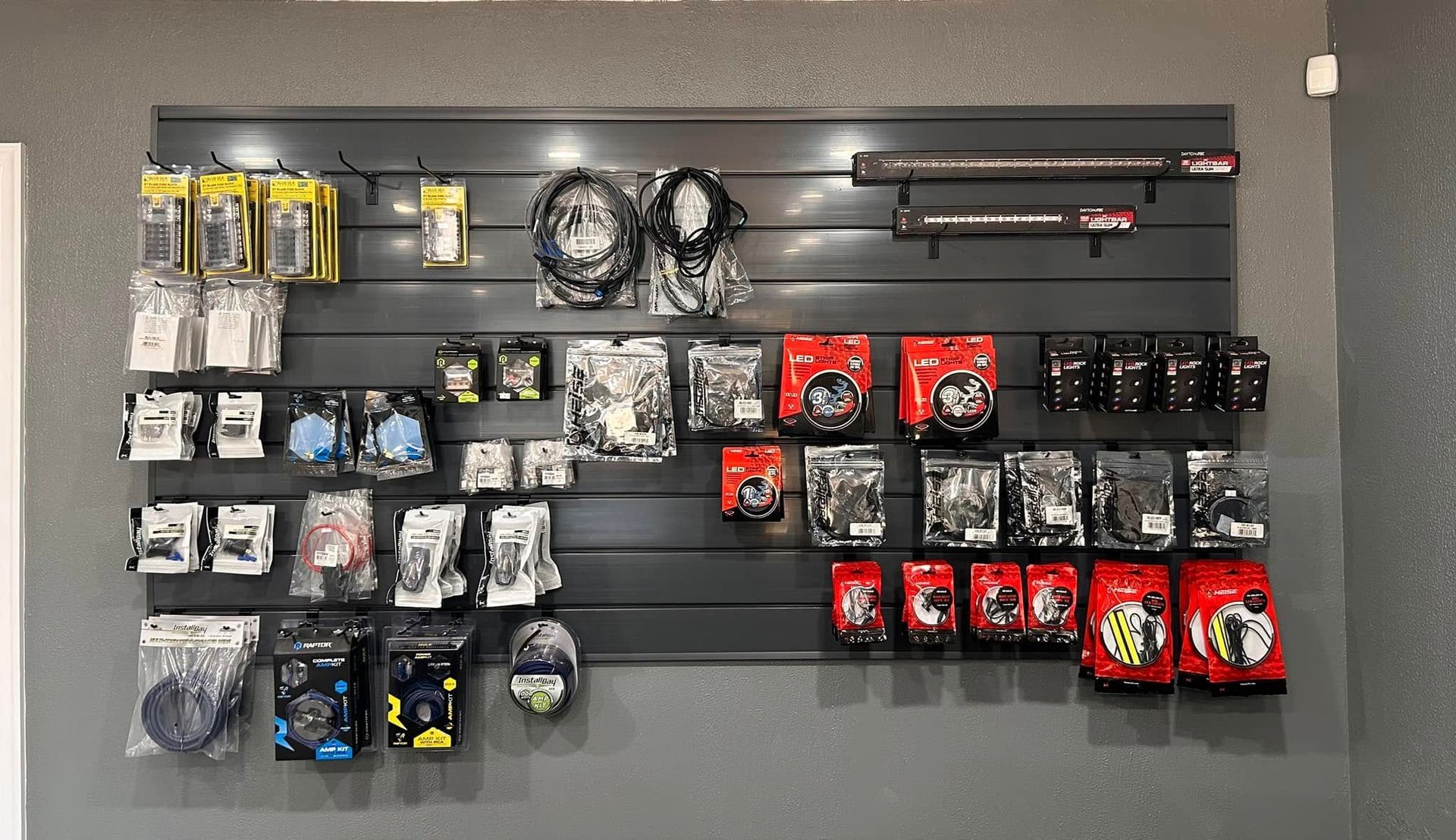 A wall display in a store showcasing various packaged electronic components and accessories.