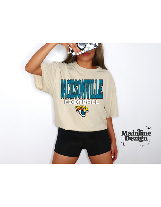 A woman is wearing a jacksonville football t-shirt and black shorts.