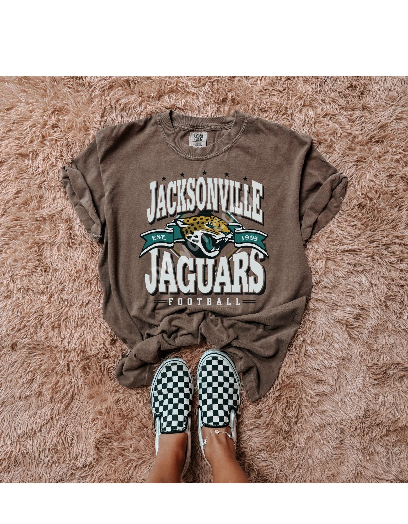 A person is wearing a jacksonville jaguars t-shirt and checkered vans shoes.