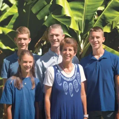 A group of people in blue shirts are posing for a picture