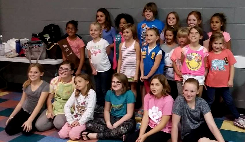 A group of young girls are posing for a picture