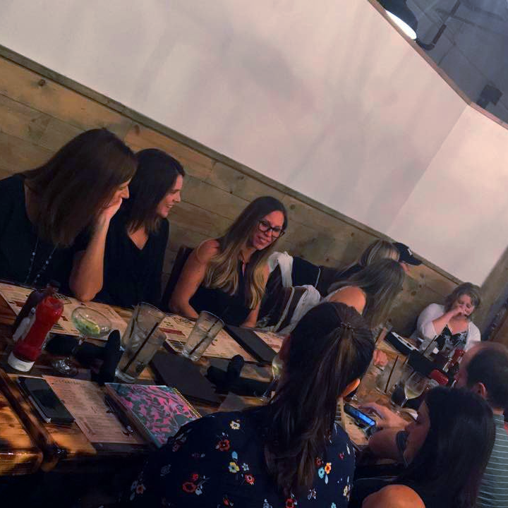 A group of women are sitting at a table in a restaurant