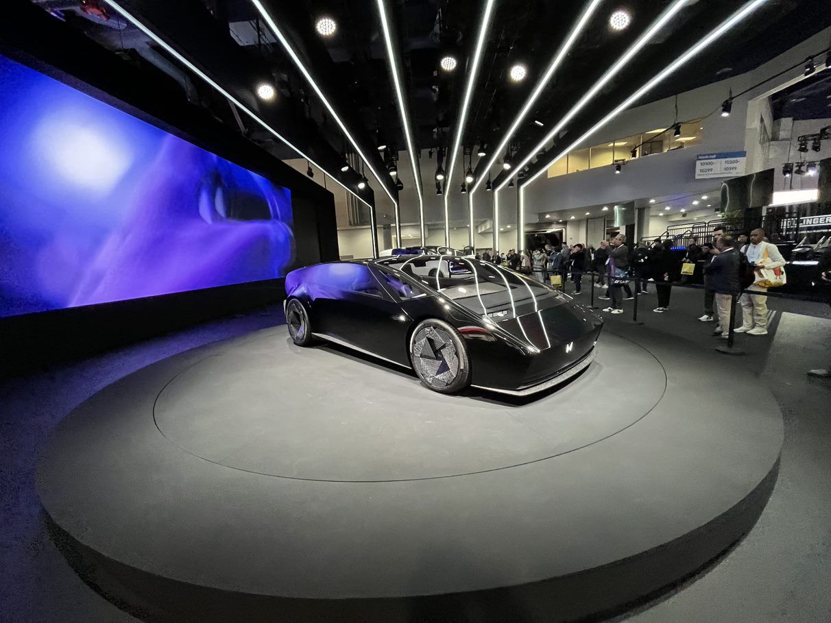 Honda's sporty electronic vehicle sitting on top a Smartstage revolving platform. Smartstage's heavy-duty stages are available for sale or for rent for corporate brand exhibits and displays.