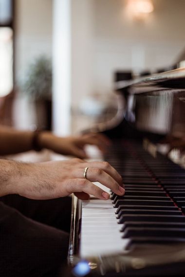Man Hand with Ring Playing a Piano — Piano Tuner in Taree, NSW