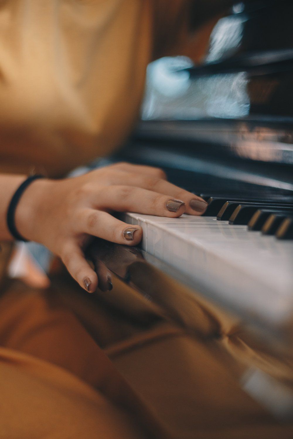 Female Hand Touching the Keys of Piano — Piano Tuner Near Me in Forster, NSW