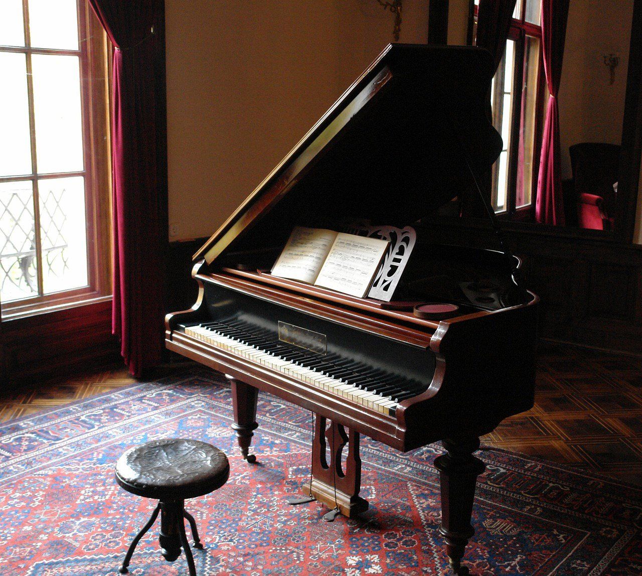 Piano with Music Sheet and Chair side view — Piano Tuner Near Me in Port Macquarie, NSW