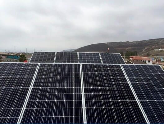 Una fila de paneles solares colocados encima de un techo.
