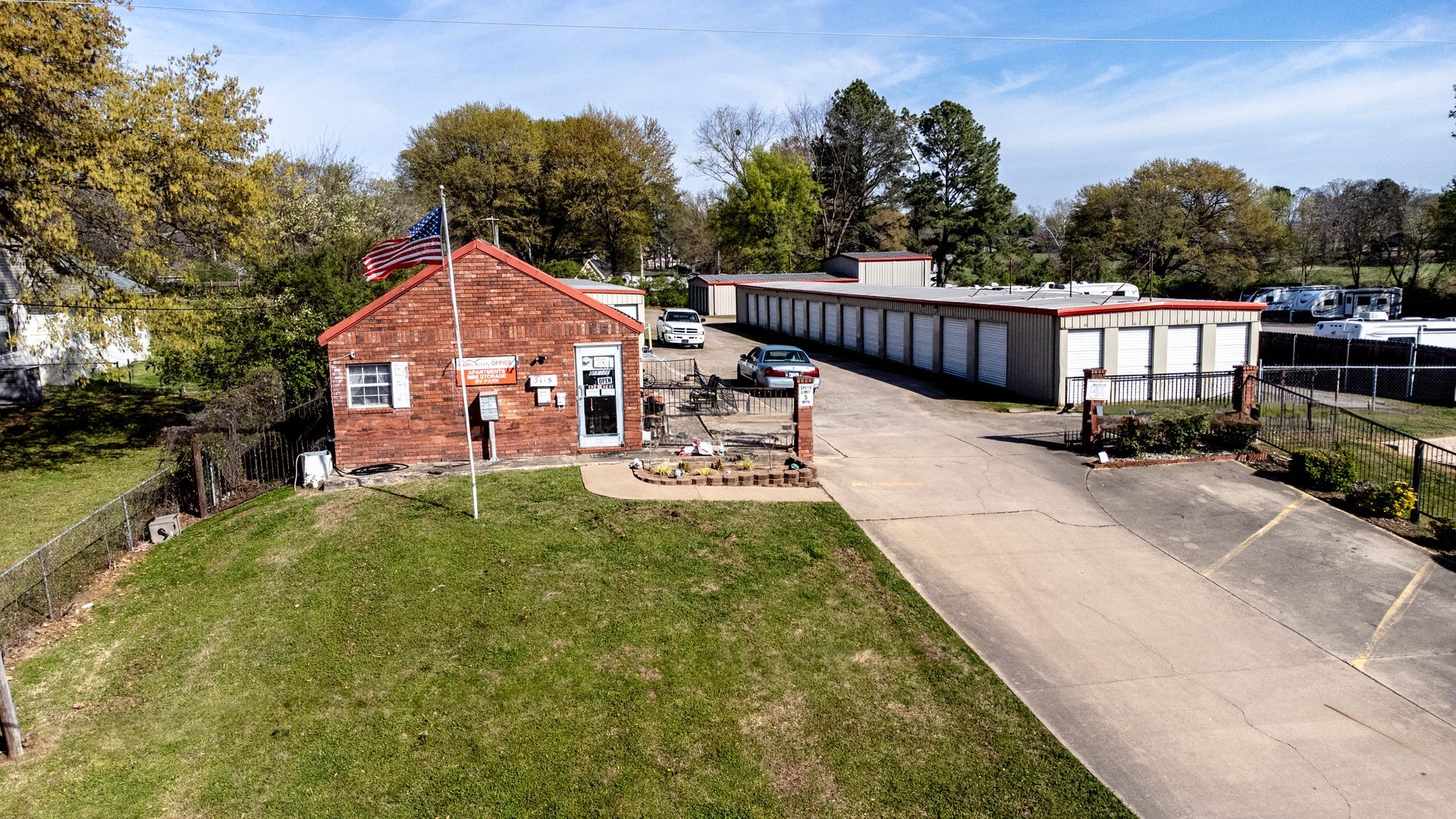 An aerial view of a brick building next to a parking lot.