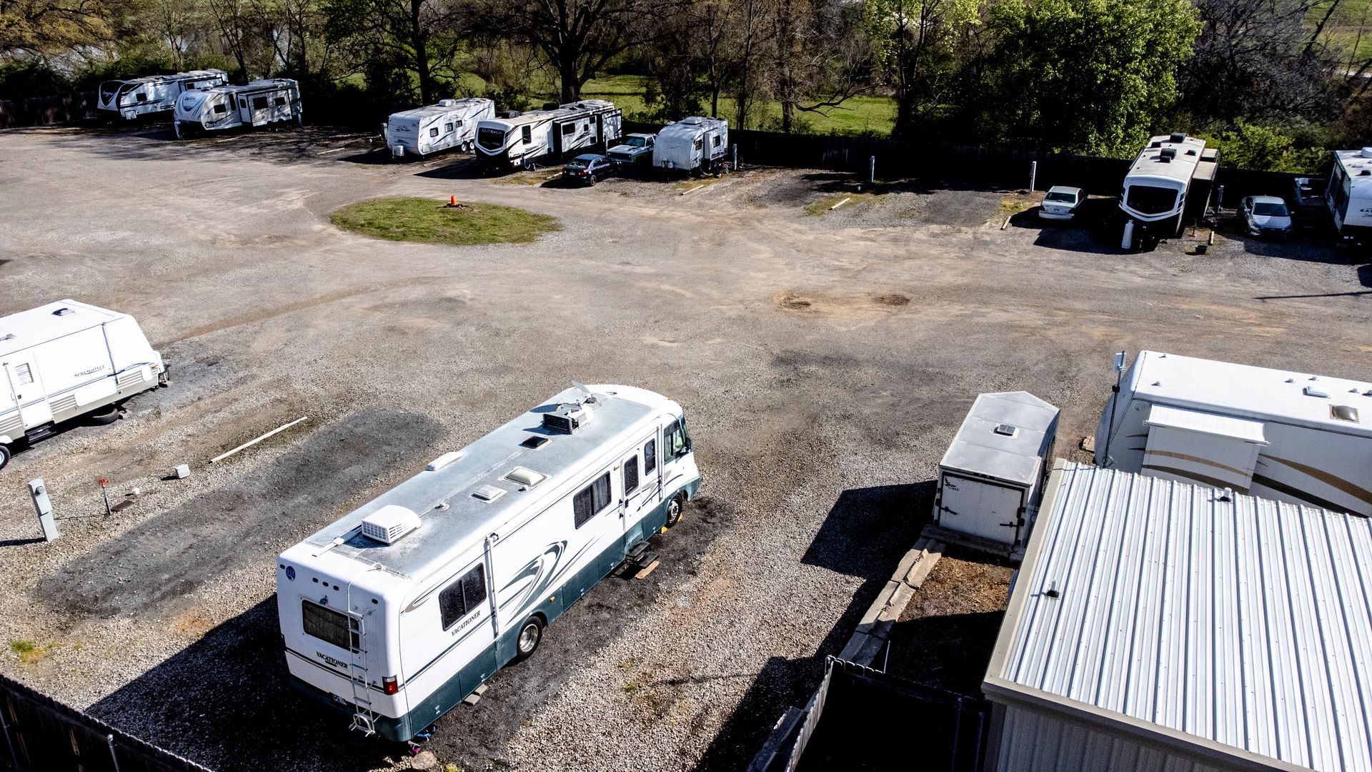 An aerial view of a parking lot filled with rvs and trailers.