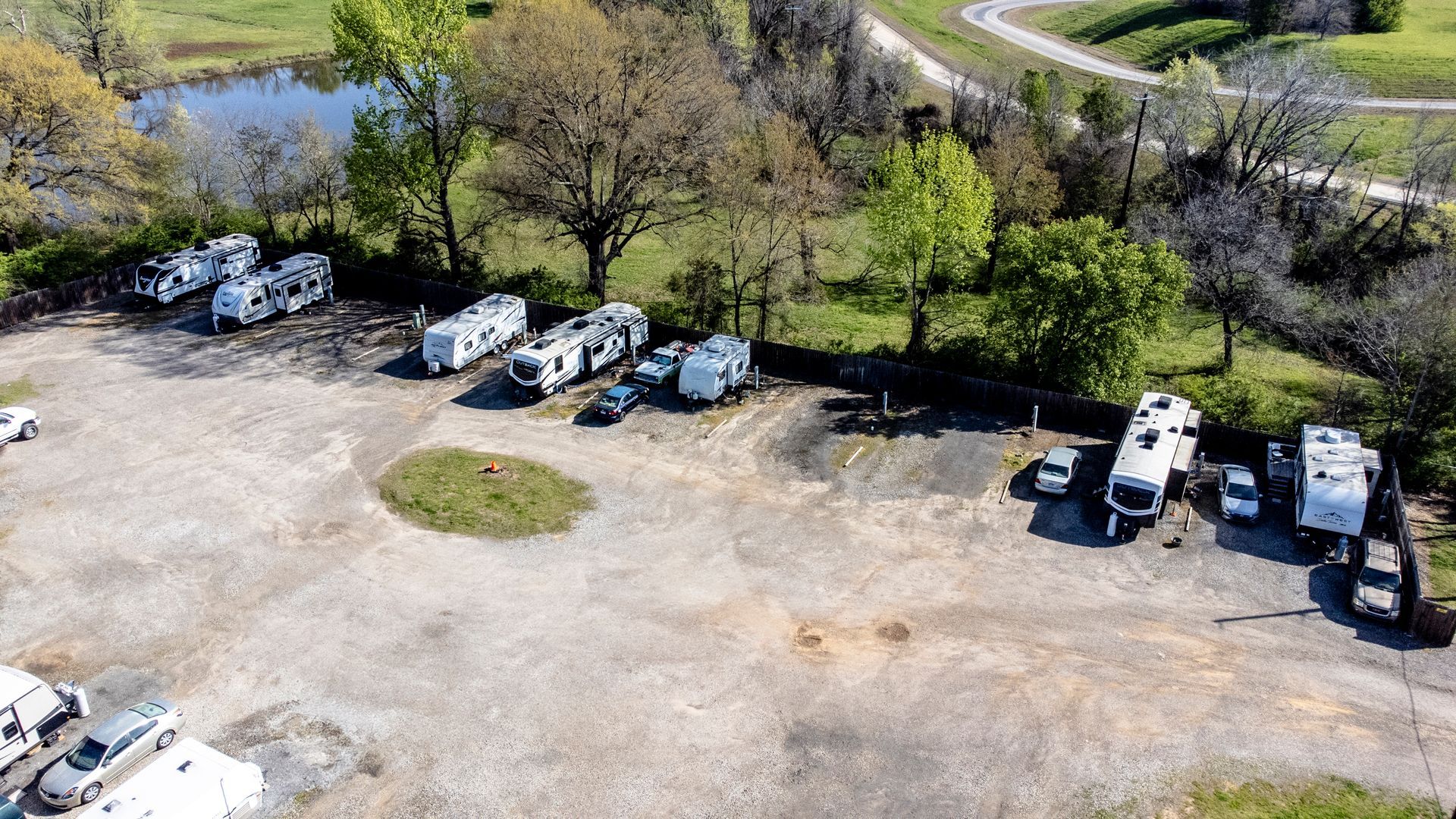 An aerial view of a row of rvs parked in a parking lot.