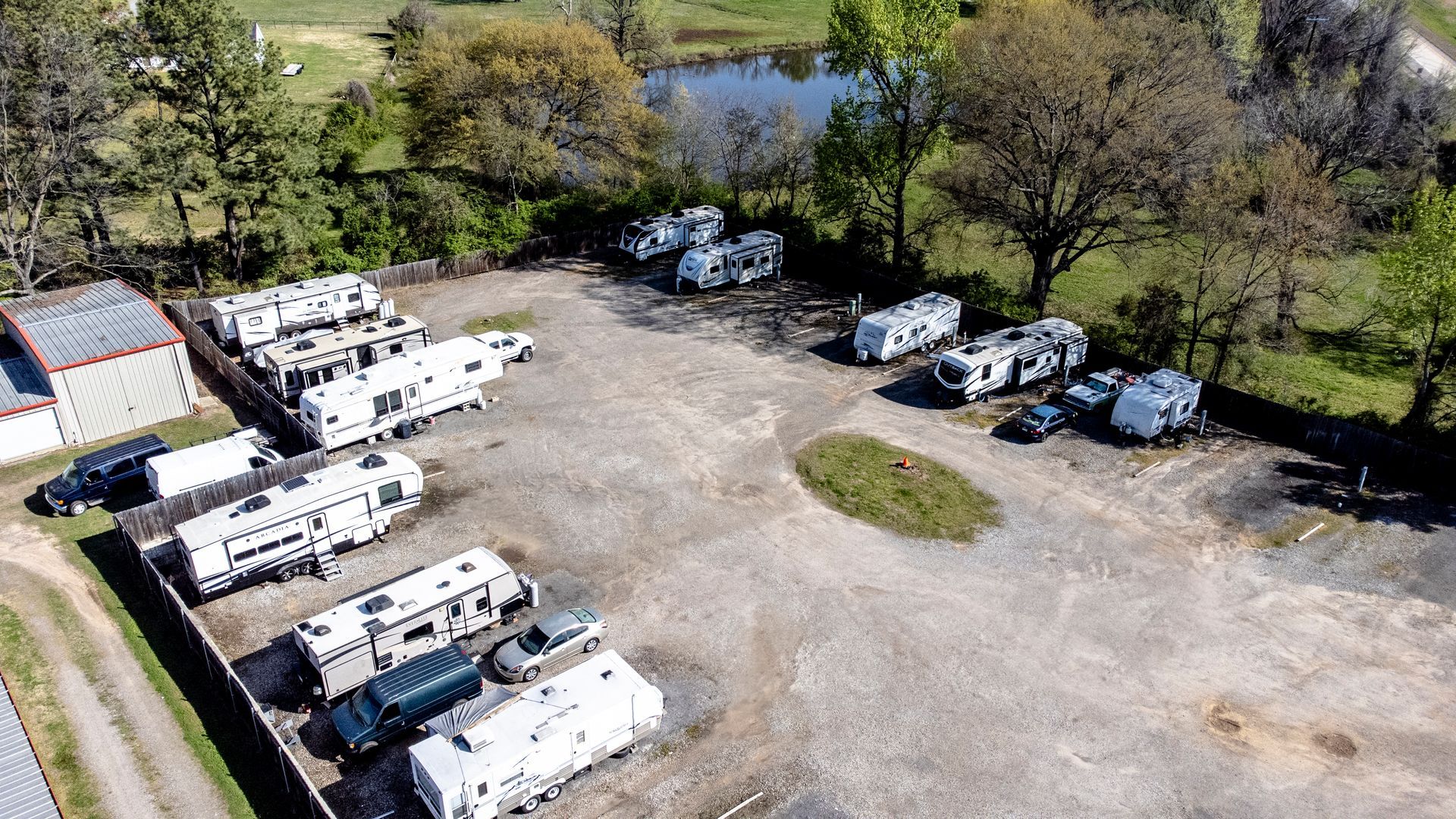 An aerial view of a parking lot filled with rvs.