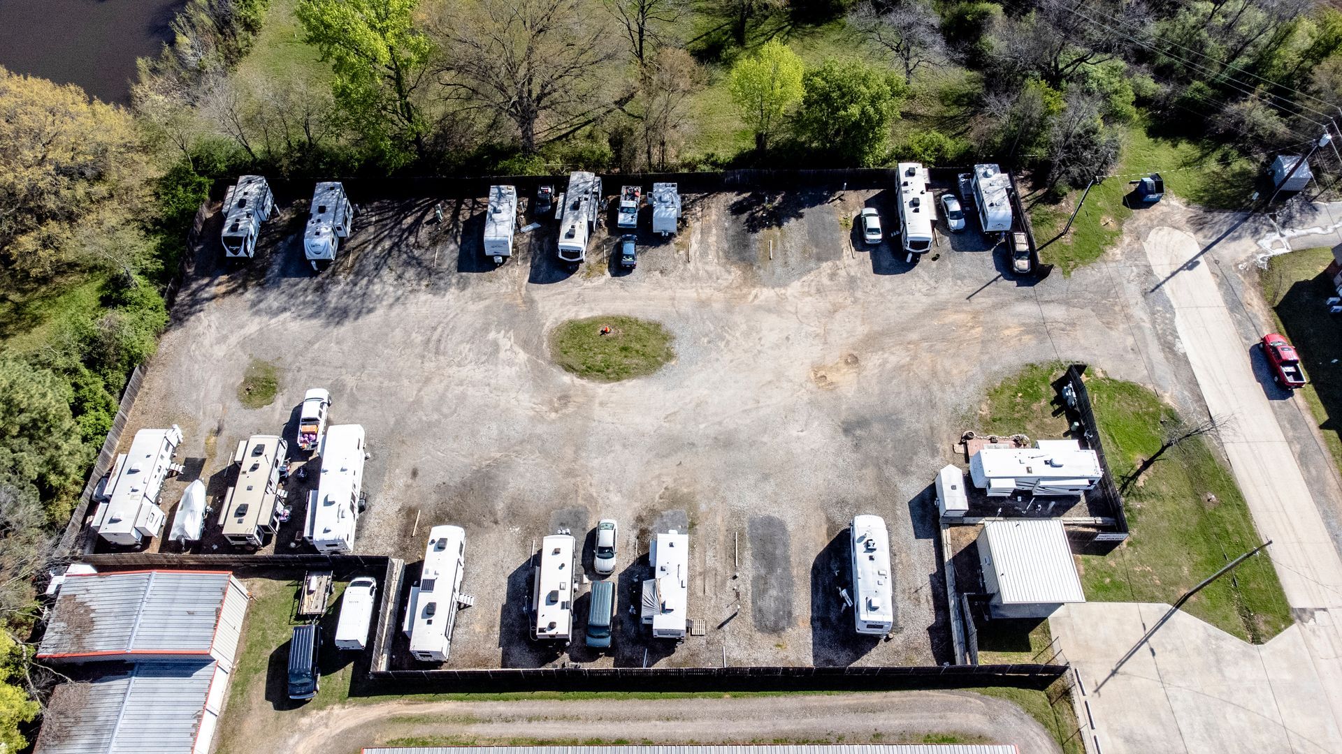 An aerial view of a parking lot with a lot of cars parked in it.