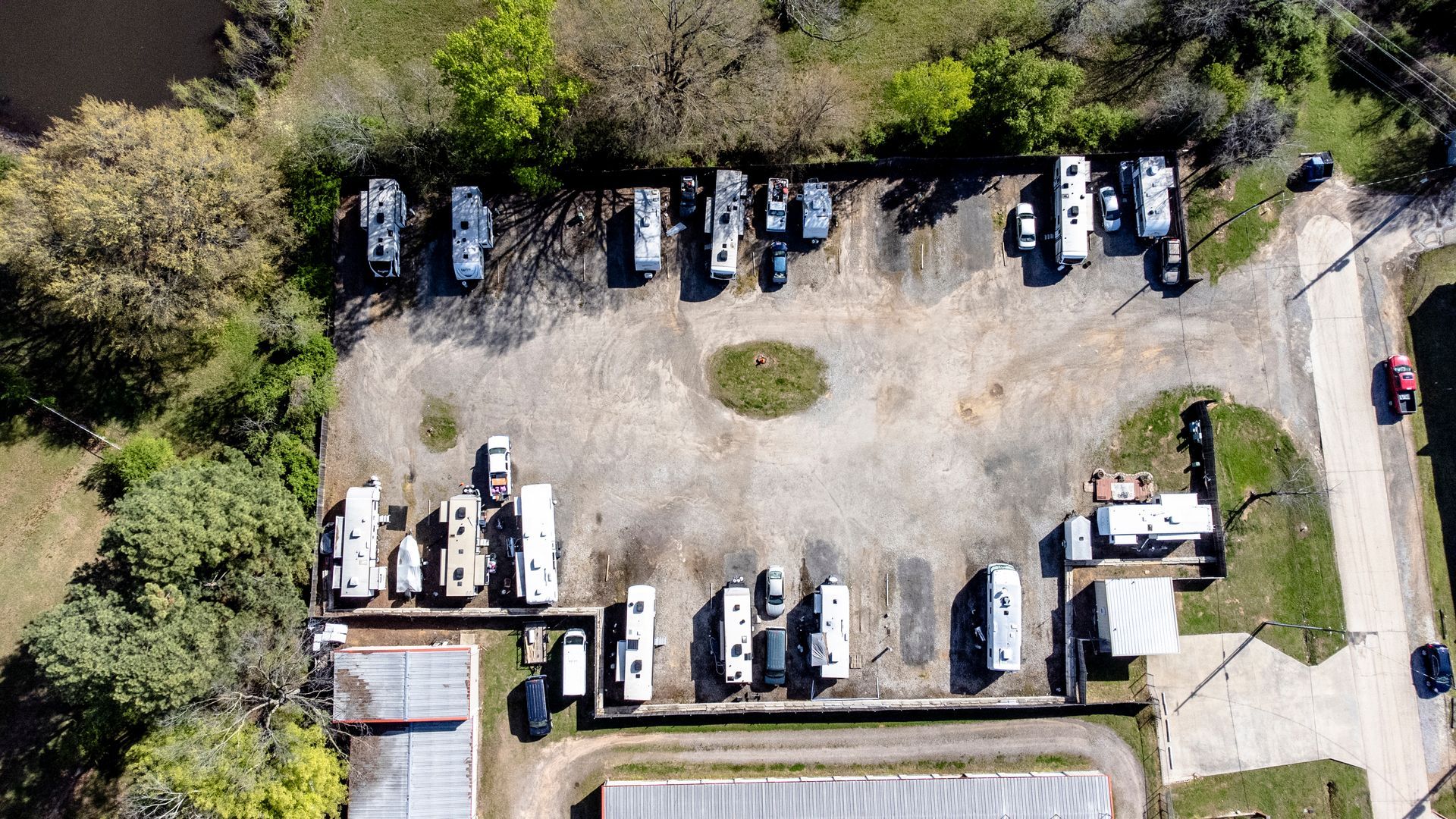 An aerial view of a parking lot with a lot of cars parked in it.