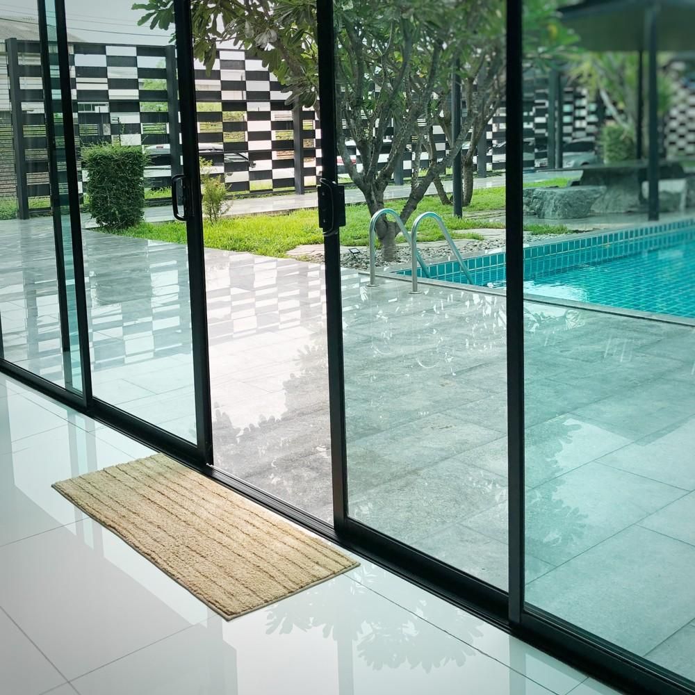 A Sliding Glass Door Leads To A Swimming Pool — Northern Glazing Glass & Aluminium In Smithfield, QLD