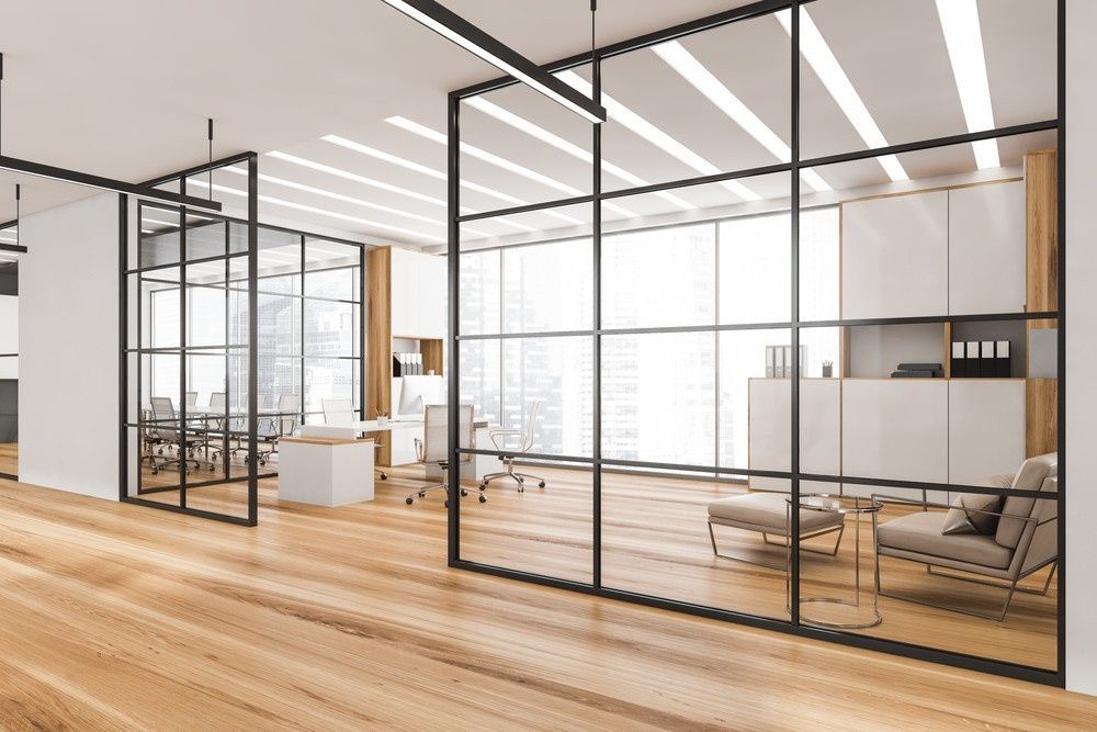 A Modern Office With A Lot Of Windows And A Wooden Floor — Northern Glazing Glass & Aluminium In Smithfield, QLD