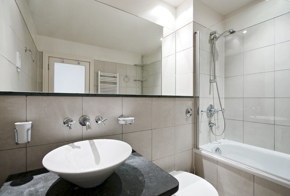 A Bathroom With A Sink, A Toilet And A Bathtub — Northern Glazing Glass & Aluminium In Smithfield, QLD