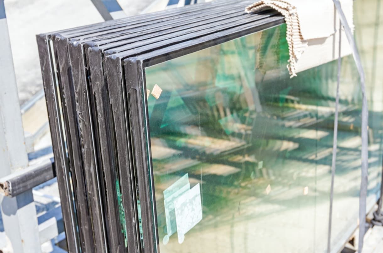 A Stack Of Glass Sitting On Top Of Each Other On A Shelf — Northern Glazing Glass & Aluminium In Smithfield, QLD