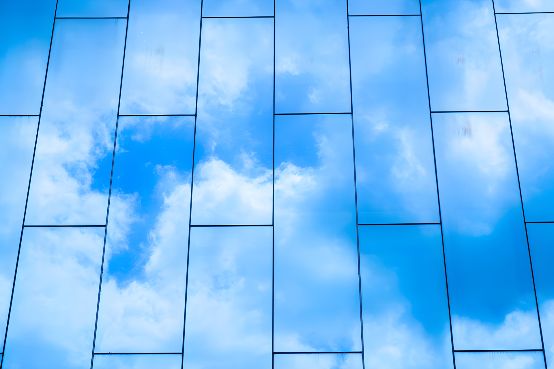 A Man Wearing Yellow Gloves Is Installing A Window — Northern Glazing Glass & Aluminium In Smithfield, QLD